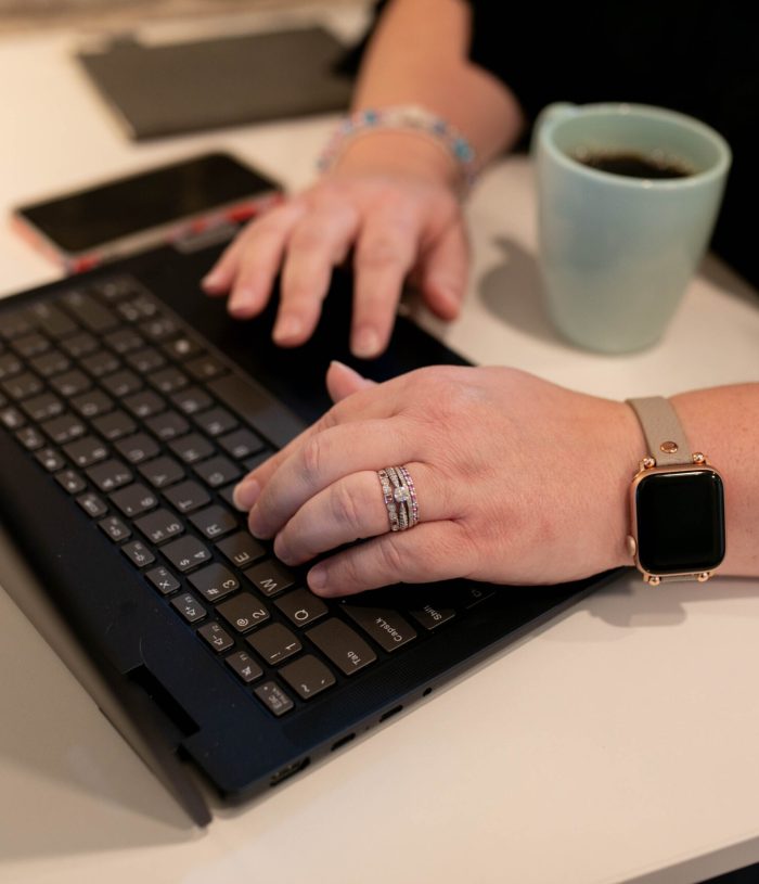 Close up of a woman working on a laptop